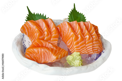 Salmon sashimi, Japanese food. Raw salmon fillet served on ice with wasabi and grated white radish isolated on white background, clipping path included.