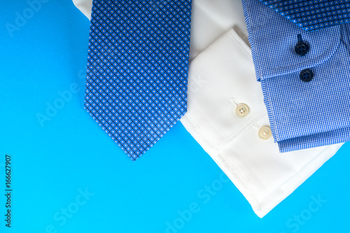 Stack of blue and white shirt closeup on a light background.