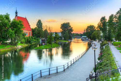 Architecture of Bydgoszcz city with reflection in Brda river at sunset, Poland