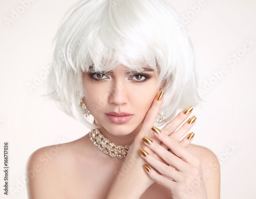 Beauty Blonde. Blond bob hairstyle. Manicured nails. Fashion girl model with makeup, short hair, golden jewelry set isolated on white background.