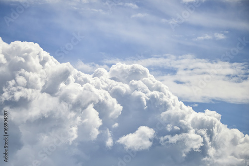 Dramatic cumulus clouds with high level cirrocumulus clouds for use as background