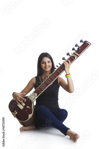 Young woman playing the sitar