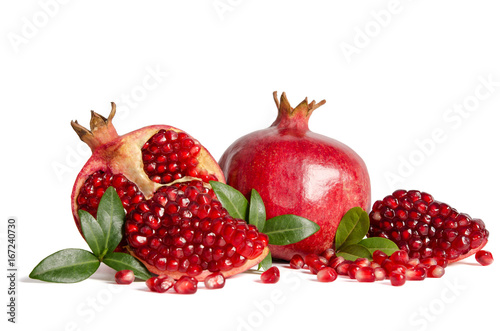 whole Pomegranates and three part of Pomegranate with leaves and seeds isolated on white