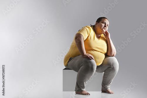 Obese woman thinking