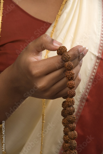 Woman holding prayer beads 