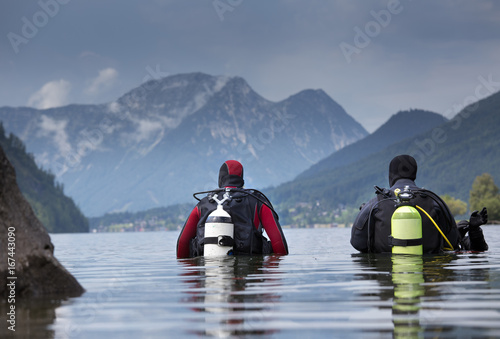 Divers entering water in mountain lake