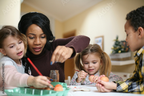 Woman with three child. African American woman with three child prepare for Easter.