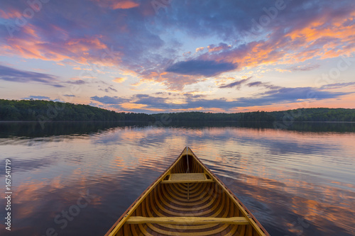 Bow of a cedar canoe on a lake at sunset - Ontario, Canada