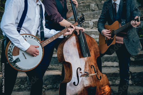 Trio of musicians with a guitar, banjo and contrabass