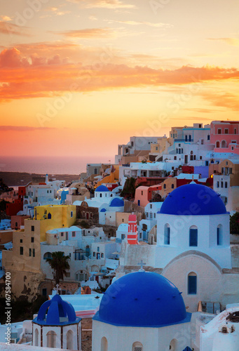 townscape of Oia, traditional greek village of Santorini, with blue domes of churches at sunset, Greece, retro toned