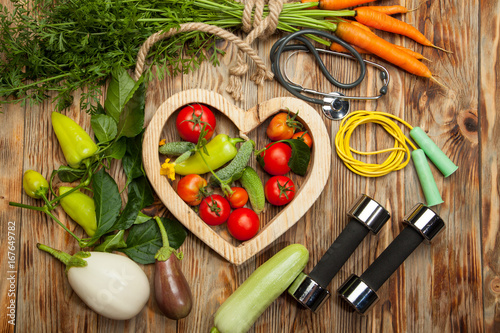 Sport and diet. Fresh vegetables. Healthy lifestyle. Rustic wooden background.