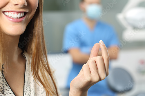 Dentist patient hand holding a blank product