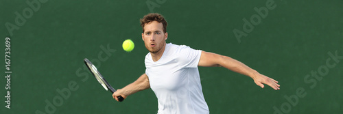 Tennis player man banner hitting ball with racket on green horizontal copy space background. Sports athlete training forehand grip technique on outdoor court.
