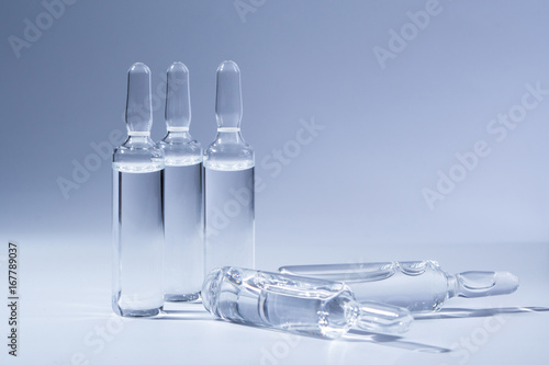 Medical ampules for injection isolated on blue background