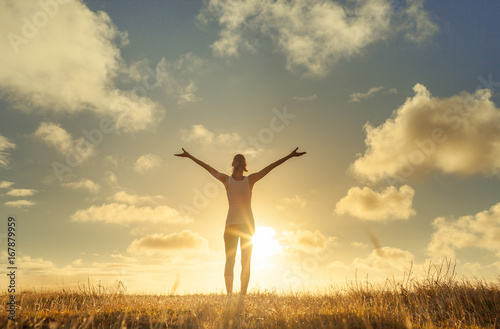 Happy woman with arms in air feeling free.