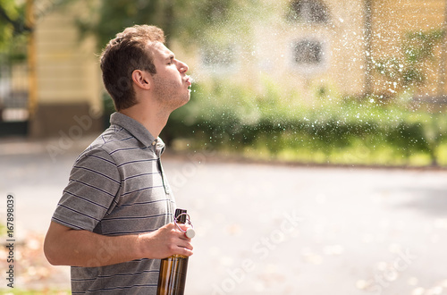 Young man spit out alcohol