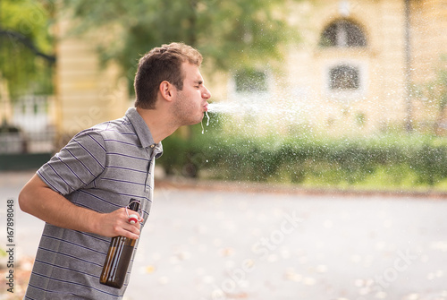 Young man spit out alcohol