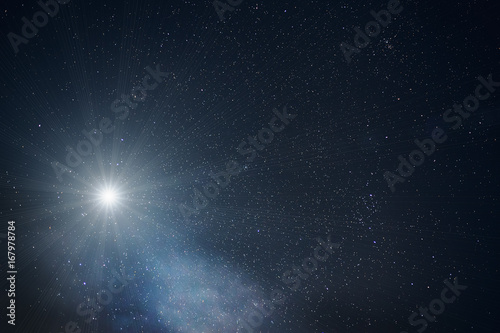 One bright big star in night sky with lots of stars