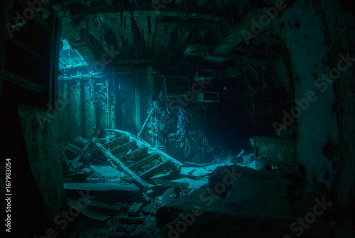 a natural light shot of the inside of the shipwreck of the captain keith tibbetts in little cayman. The inside of this room is a spooky image as the sun lights up a small section