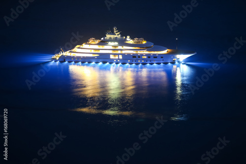 An illuminated luxury yacht in the Adriatiac sea at night in Dalmatia, Croatia.