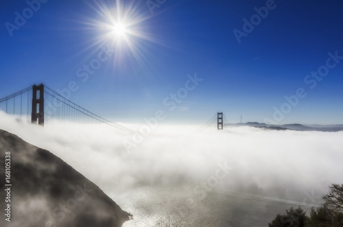 Golden Gate Bridge in the fog under the sun, San Francisco, California, USA