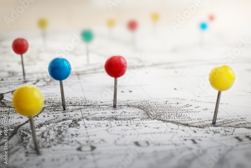 Pin marking location on map. Adventure and travel theme grunge background.