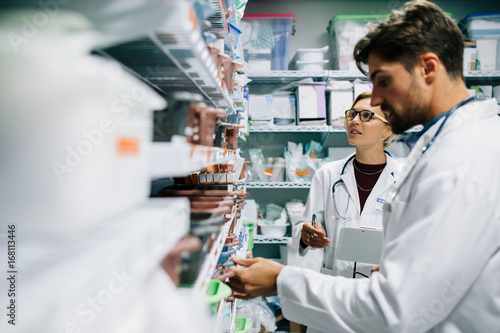 Pharmacists checking inventory at hospital pharmacy