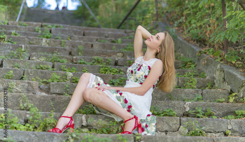 Beautiful girl sitting on stone steps