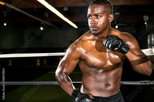 Powerful stance pose of a mma fighter in action during a routine spar session ready to combat