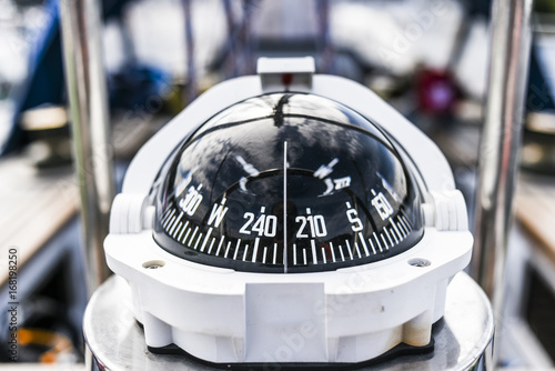A compass, a front view from on a sailing yacht.