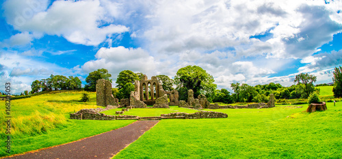 Inch Abbey with a blue sky in Northern Ireland. Monastery ruins in Downpatrick. Co. Down. Travel by car in summer.