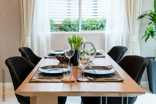 Wooden table and chair in modern dinning room at home. Interior of dinning room at home.