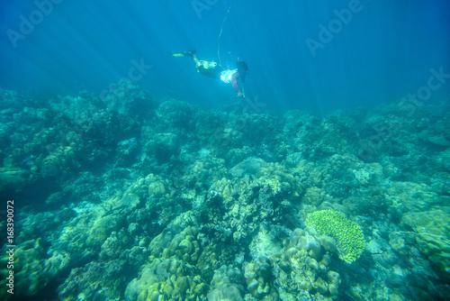 Snorkeling at the coral reef with sling shot on fish hunting