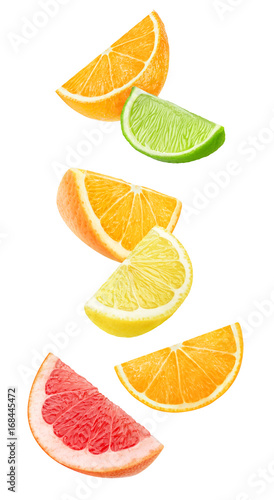 Isolated citrus fruits wedges. Floating pieces of orange, lemon, lime and grapefruit isolated on white background with clipping path