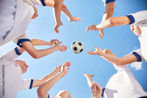 Junior Football Team Throwing Ball