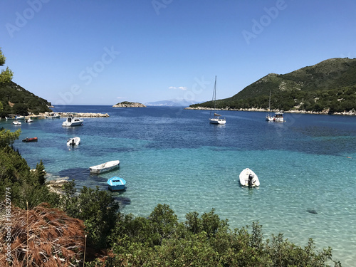 Boats on the turquoise sea of Atheras beach in Cephalonia or Kefalonia, Greece