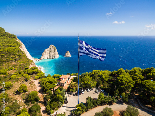 Greek biggest national flag waving in the sky in Keri in Zakynthos (Zante) island in Greece