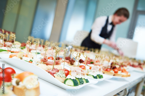 Restaurant waitress serving table with food