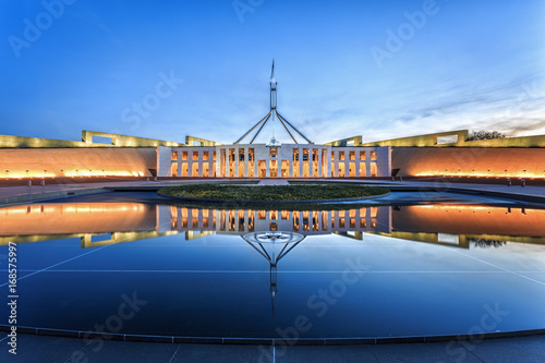 Dramatic evening sky over Parliament House, illuminated at twilight. Which was the world's most expensive building when it was completed in 1988 in Canberra, Australia