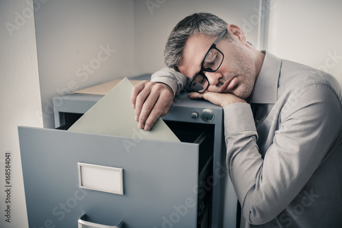 Tired office worker sleeping in the office