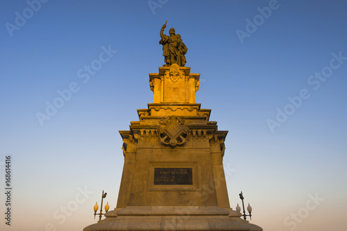 Monument to Roger of Lauria (an Aragonese admiral of the XIII century) in sunset rays, located in Tarragona, Spain