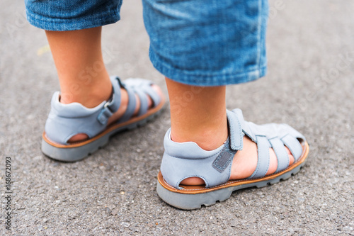 Close up image of new beautiful kids shoes on child's feet
