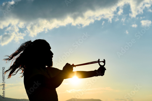 silhouette of the man who throws slingshot