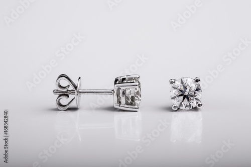 Pair of Diamond and white gold stud earrings on white background