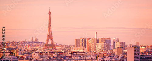 Panoramic skyline of Paris with the Eiffel tower at sunset, Montmartre in the background, France and Europe city travel concept