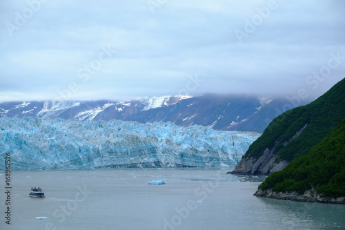 Small boat in front of the Hubbard Glacier in Alaska