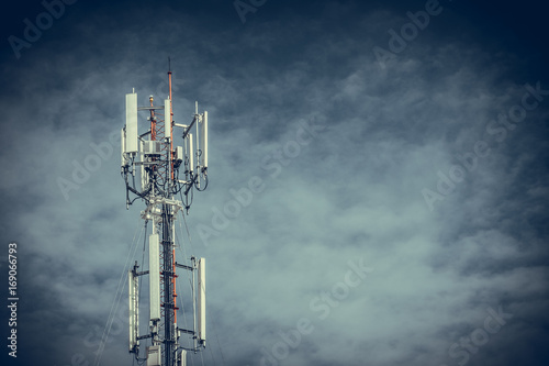 Mobile phone communication antenna tower with the blue sky and clouds