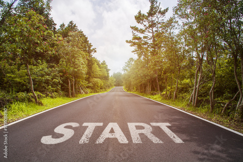 Start sign over asphalt road