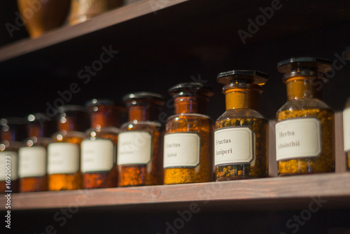 Vintage alchemy chemistry workshop rack shelf and glass vials ingredients