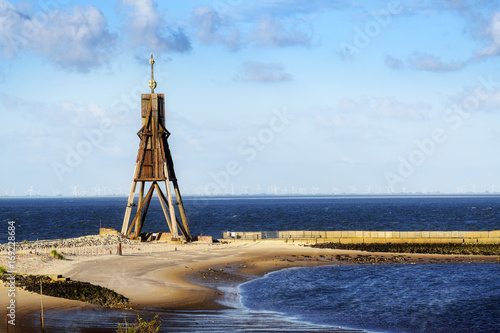 Kugelbake, old sea sign and landmark against the blue sky, symbol of the town Cuxhaven on the North Sea in Germany, copy space